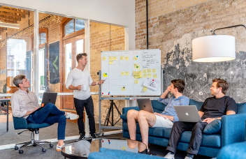 Manager showing project presentation to his colleagues